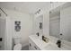 Clean bathroom with white cabinets, double sinks, mirrors, and shower-tub combo at 3308 Wildwood Sw Dr, Marietta, GA 30060