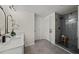 Modern bathroom featuring a sleek glass enclosed shower and dual sink vanity at 3308 Wildwood Sw Dr, Marietta, GA 30060
