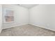 Well-lit bedroom with a window and neutral carpeting at 6233 Thorncrest Dr, Tucker, GA 30084