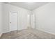 Spacious bedroom with neutral walls, carpet, and two doors at 6233 Thorncrest Dr, Tucker, GA 30084