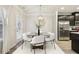 Bright dining room features a glass table with six chairs and modern chandelier at 6233 Thorncrest Dr, Tucker, GA 30084