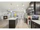 Modern kitchen with island, stainless steel appliances, and hardwood floors at 6233 Thorncrest Dr, Tucker, GA 30084