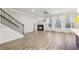 Open living area with hardwood floors, fireplace, and access to staircase at 6233 Thorncrest Dr, Tucker, GA 30084