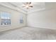 Main bedroom with carpet, ceiling fan and two windows at 6233 Thorncrest Dr, Tucker, GA 30084