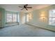Main bedroom with window seat, ceiling fan and carpet at 118 Knotts Landing Dr, Woodstock, GA 30188