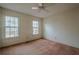 Well-lit bedroom with ceiling fan and neutral carpeting at 118 Knotts Landing Dr, Woodstock, GA 30188