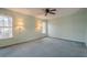 Bright bedroom with wall sconces, ceiling fan and carpet at 118 Knotts Landing Dr, Woodstock, GA 30188