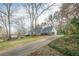 Exterior view of a house with a long driveway leading up to the front door at 118 Knotts Landing Dr, Woodstock, GA 30188