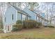 Ranch style home with light blue siding, stone accents, and mature landscaping at 118 Knotts Landing Dr, Woodstock, GA 30188