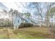 Side view of a charming light blue house with stone foundation and lush lawn at 118 Knotts Landing Dr, Woodstock, GA 30188