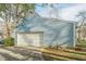 Attached garage with light blue siding and a white door at 118 Knotts Landing Dr, Woodstock, GA 30188