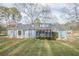 Back exterior of house with landscaping and yard at 118 Knotts Landing Dr, Woodstock, GA 30188