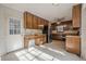 Kitchen with wood cabinets, appliances, and adjacent dining area at 118 Knotts Landing Dr, Woodstock, GA 30188