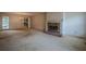 Spacious living room featuring a brick fireplace and view into dining area at 118 Knotts Landing Dr, Woodstock, GA 30188