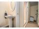 Small bathroom with pedestal sink and access to additional storage at 130 Wesleyan Way, Oxford, GA 30054