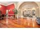 Formal dining room with hardwood floors and red accent wall at 130 Wesleyan Way, Oxford, GA 30054