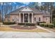 Brick home with a large front porch and landscaped yard at 130 Wesleyan Way, Oxford, GA 30054