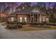 Brick home with a large front porch and landscaped yard at 130 Wesleyan Way, Oxford, GA 30054