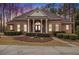 Brick home with a large front porch and landscaped yard at 130 Wesleyan Way, Oxford, GA 30054