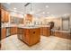 Open kitchen boasts an island, hardwood floors, and stainless steel appliances at 130 Wesleyan Way, Oxford, GA 30054