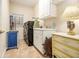 Bright laundry room with washer, dryer, and plenty of cabinet storage at 130 Wesleyan Way, Oxford, GA 30054