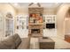 Living room with built-in shelving, stone fireplace, and hardwood floors at 130 Wesleyan Way, Oxford, GA 30054