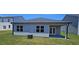 Home exterior showing back patio and well-maintained lawn at 8587 Seabiscuit Rd, Lithonia, GA 30058