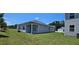 Backyard of home showing patio area, and manicured lawn at 8587 Seabiscuit Rd, Lithonia, GA 30058