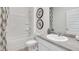 Bright bathroom featuring a shower-tub combo, framed art and sleek fixtures at 8587 Seabiscuit Rd, Lithonia, GA 30058
