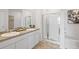 Bathroom with double sink vanity, granite countertops, tub and glass shower at 8587 Seabiscuit Rd, Lithonia, GA 30058