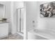 Bathroom featuring a shower with glass door, a soaking tub and neutral walls and floors at 8587 Seabiscuit Rd, Lithonia, GA 30058