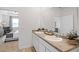 Elegant Primary bathroom with double sinks, granite counters and bright natural light at 8587 Seabiscuit Rd, Lithonia, GA 30058