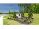 Stone community entrance sign surrounded by lush landscaping and greenery on a sunny day at 8587 Seabiscuit Rd, Lithonia, GA 30058