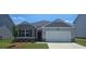 Charming single-Gathering home with a two-car garage, well-manicured lawn and inviting curb appeal at 8587 Seabiscuit Rd, Lithonia, GA 30058