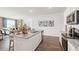 Open-concept kitchen features a large island with granite countertops, stainless steel appliances, and ample lighting at 8587 Seabiscuit Rd, Lithonia, GA 30058