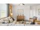 Bright living room with ample seating, hardwood floors, and modern ceiling fan at 8587 Seabiscuit Rd, Lithonia, GA 30058