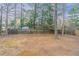 Large backyard with a wooden fence, and mature trees at 2906 Monterey Dr, Decatur, GA 30032