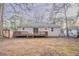 Home's back features a deck and fenced-in yard at 2906 Monterey Dr, Decatur, GA 30032