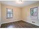 Spacious bedroom featuring two windows and dark laminate floors at 2906 Monterey Dr, Decatur, GA 30032
