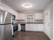 Modern kitchen with white cabinets, stainless steel appliances, and granite countertops at 2906 Monterey Dr, Decatur, GA 30032