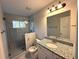 Updated bathroom with granite countertop and walk-in shower at 2148 Lilac Ln, Decatur, GA 30032