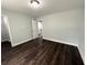 Bedroom with dark hardwood floors, neutral walls and access to upstairs hallway at 2148 Lilac Ln, Decatur, GA 30032