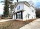 Two-story white house with black accents and driveway at 2148 Lilac Ln, Decatur, GA 30032