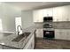 Modern kitchen with white cabinets, granite countertops, and stainless steel appliances at 2148 Lilac Ln, Decatur, GA 30032