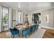 Spacious dining room with a large wooden table and blue velvet chairs at 410 Oakton Nw Ter, Marietta, GA 30064