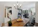 Dining area with wood table and chandelier, open to living room at 4676 Vinings Central Se Run # 104, Atlanta, GA 30339