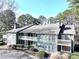 Two-story condo with multi-level porches, surrounded by mature trees and shrubbery at 4676 Vinings Central Se Run # 104, Atlanta, GA 30339