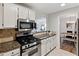 Modern kitchen with stainless steel appliances and granite countertops at 4676 Vinings Central Se Run # 104, Atlanta, GA 30339