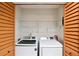 Bright laundry room with washer, dryer, and built-in shelving at 4676 Vinings Central Se Run # 104, Atlanta, GA 30339