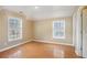 Well-lit bedroom featuring hardwood floors and two windows at 4008 Orchard Hill Ter, Stone Mountain, GA 30083
